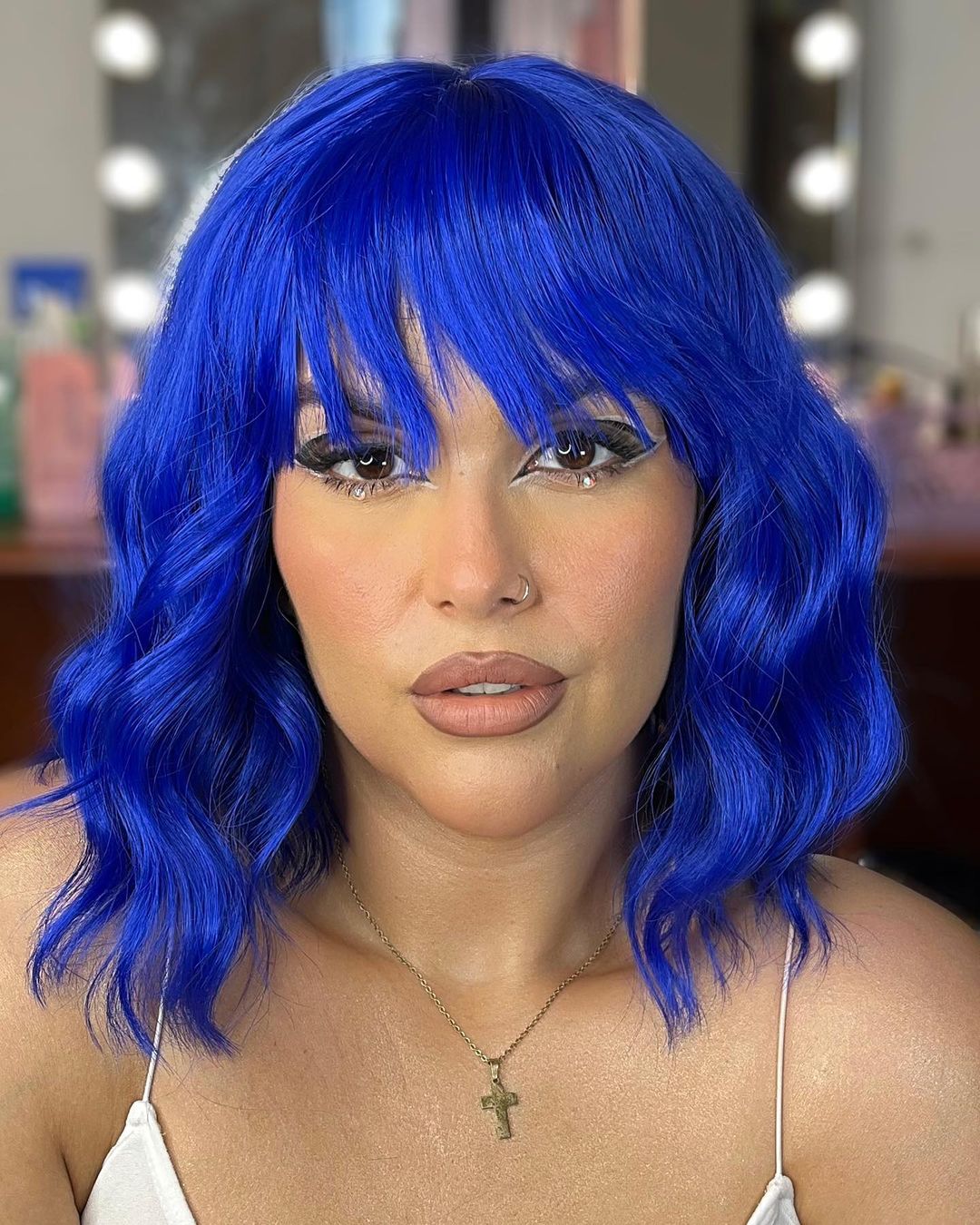 short intense blue wavy haircut with choppy bangs