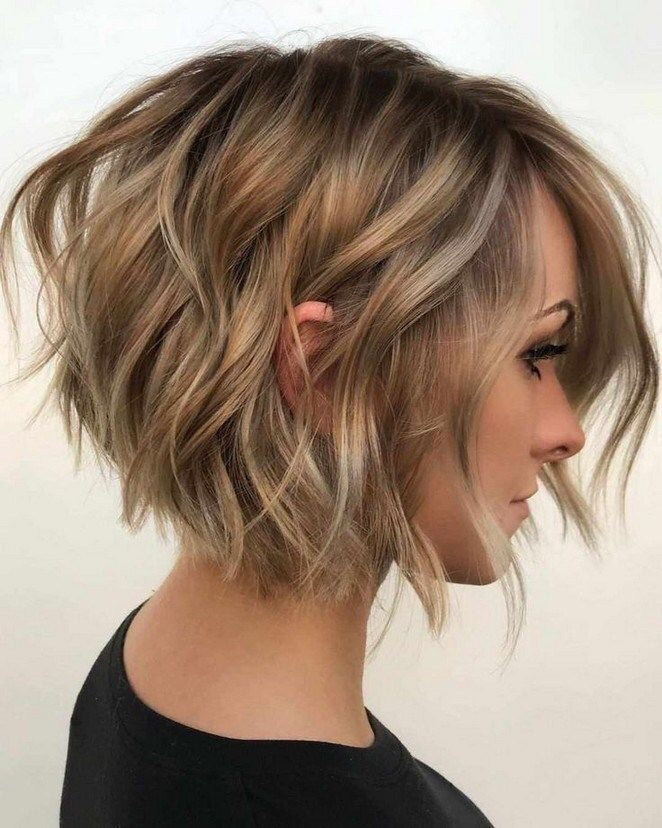 feathered wavy bob with blonde highlights