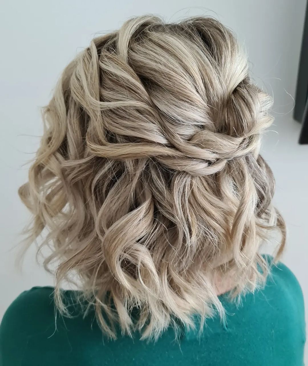 twisted half up half down short wavy hairstyle