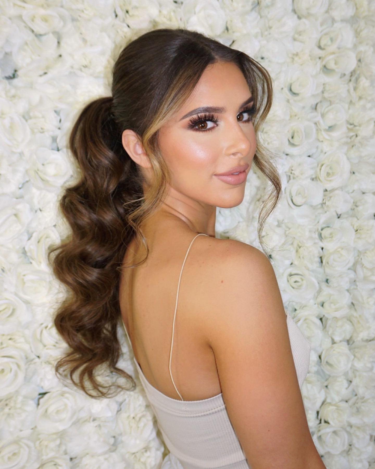high curled ponytail with face framing