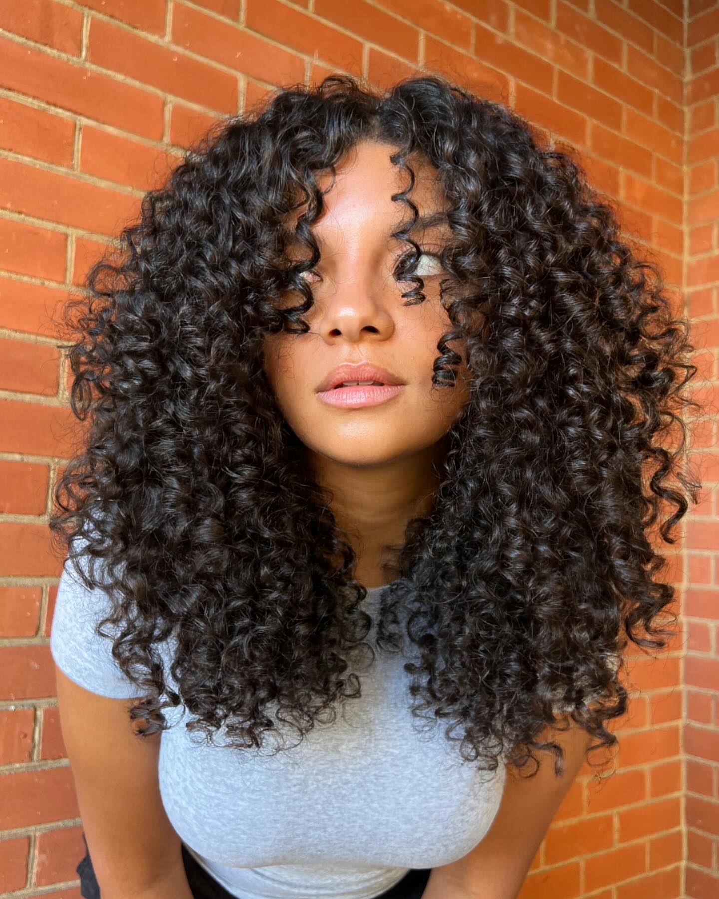 shoulder length curly hair with face framing