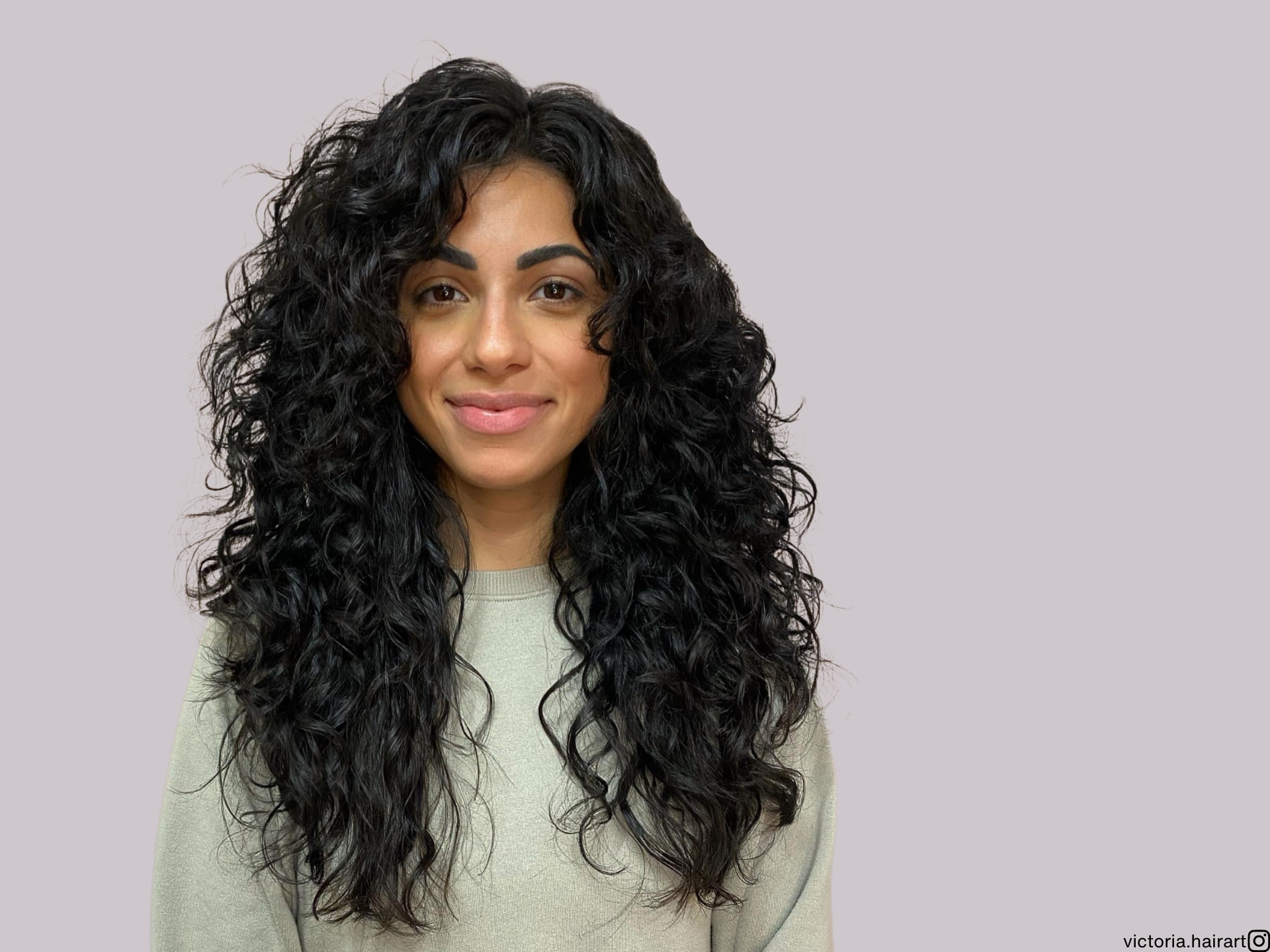 long layered curly hair with face framing