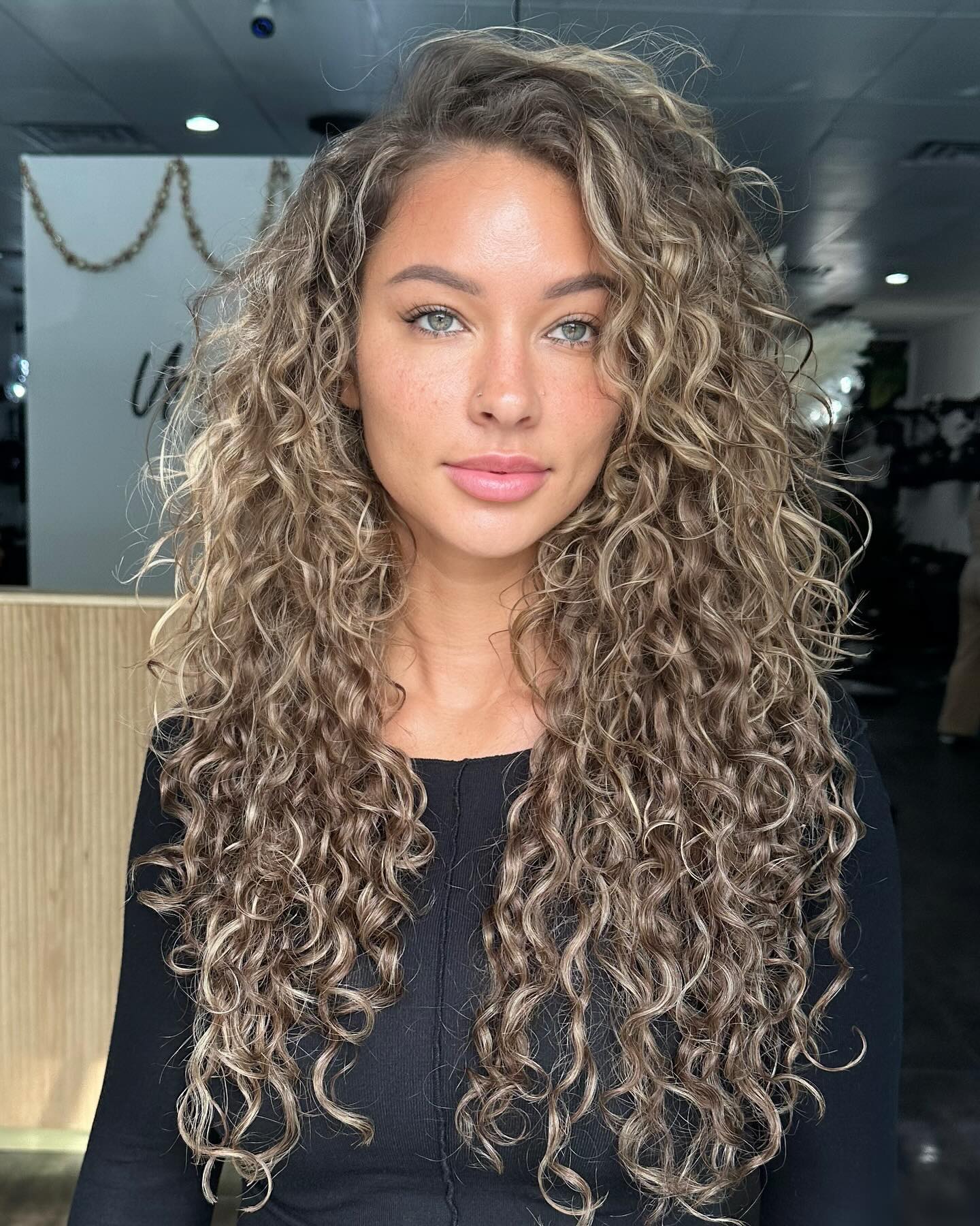 long layered blonde curly hair with face framing