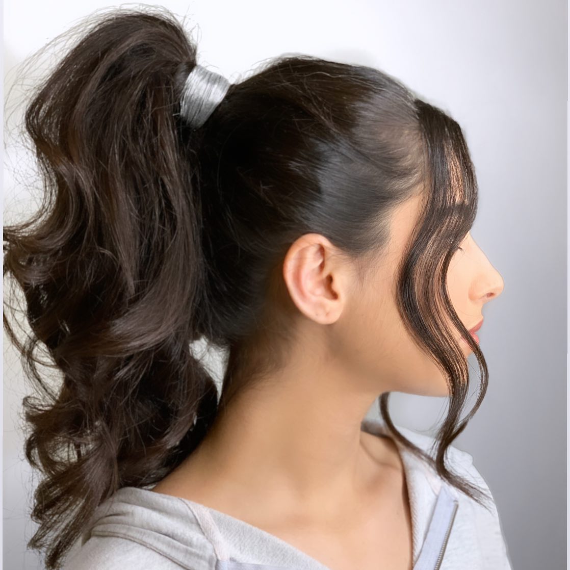 voluminous high curled ponytail