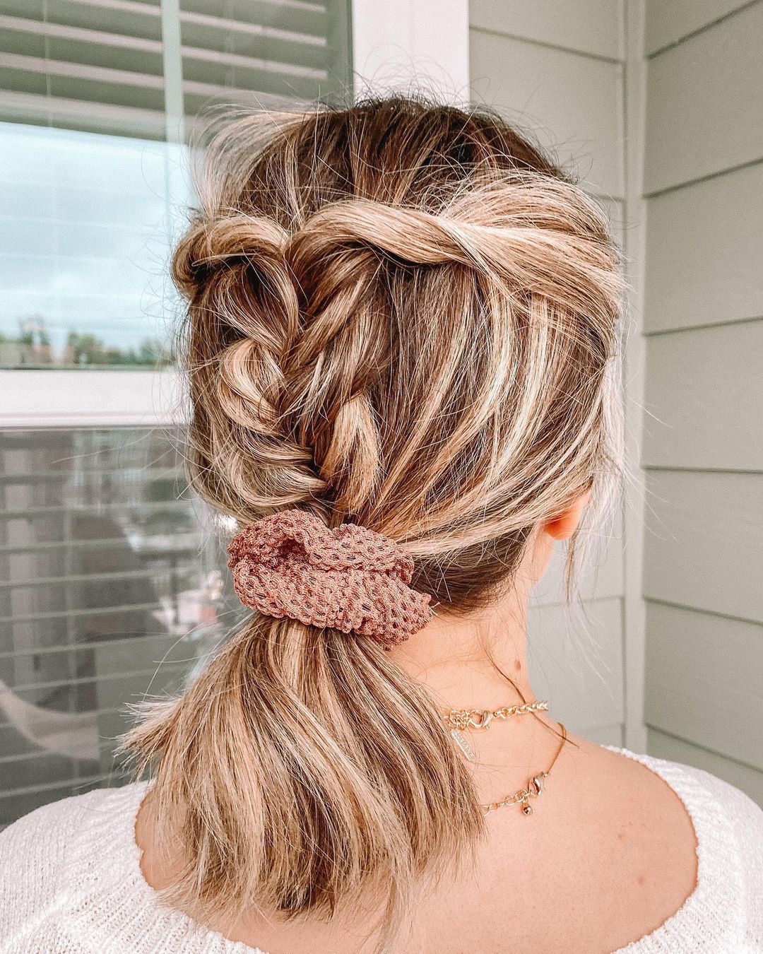 braided hairstyle with a scrunchie