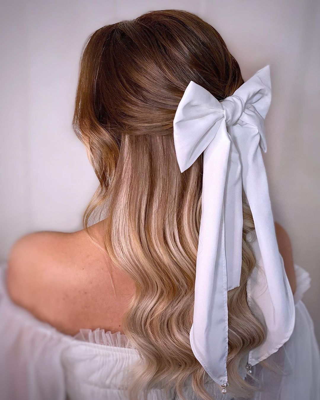 half updo with a bow
