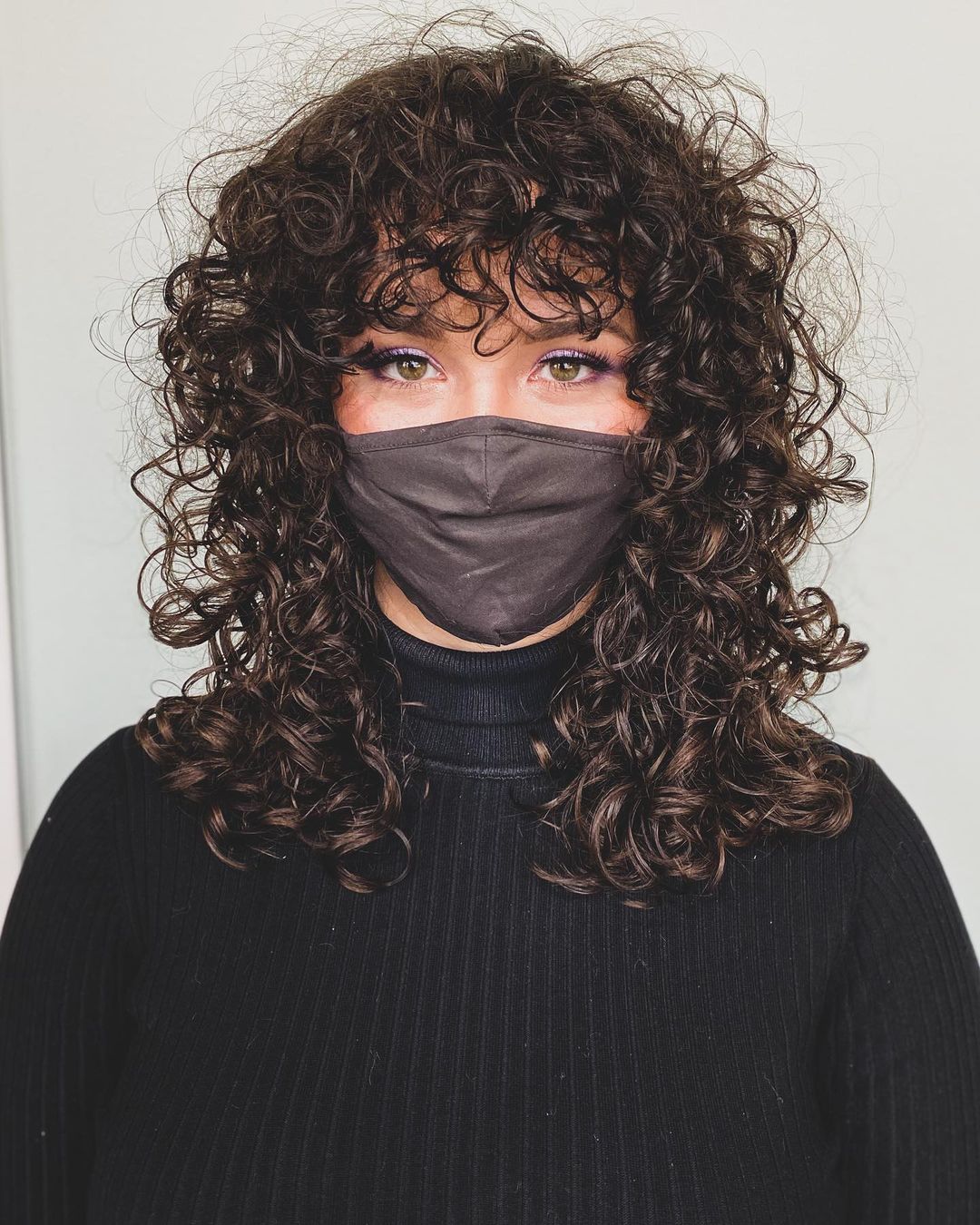 layered curly shag with full bangs