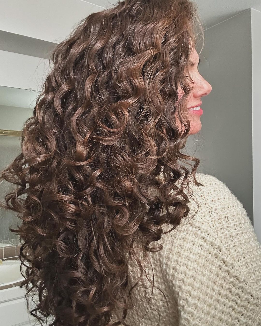 light brown curly hair with long layers