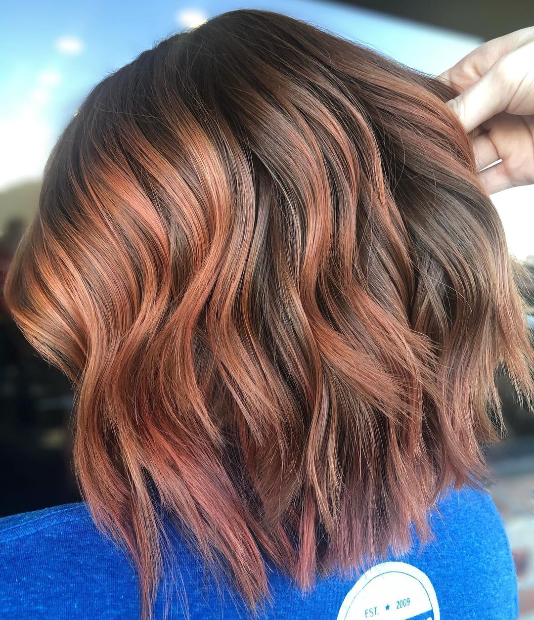 short layered cut with copper highlights