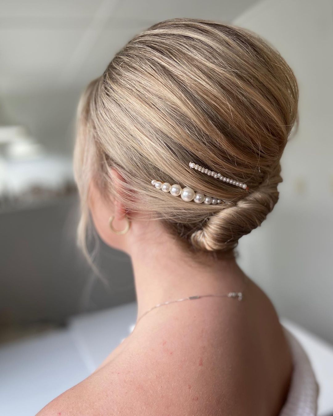 tight french roll with hair clips