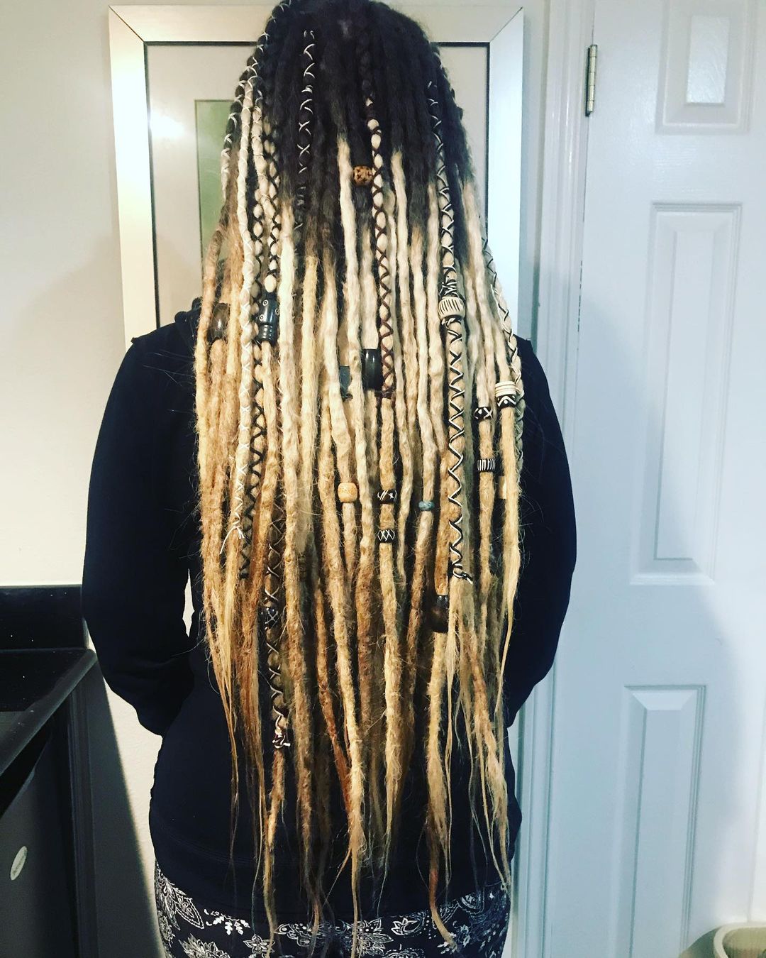 accessorized blonde ombre locs with pointy tips