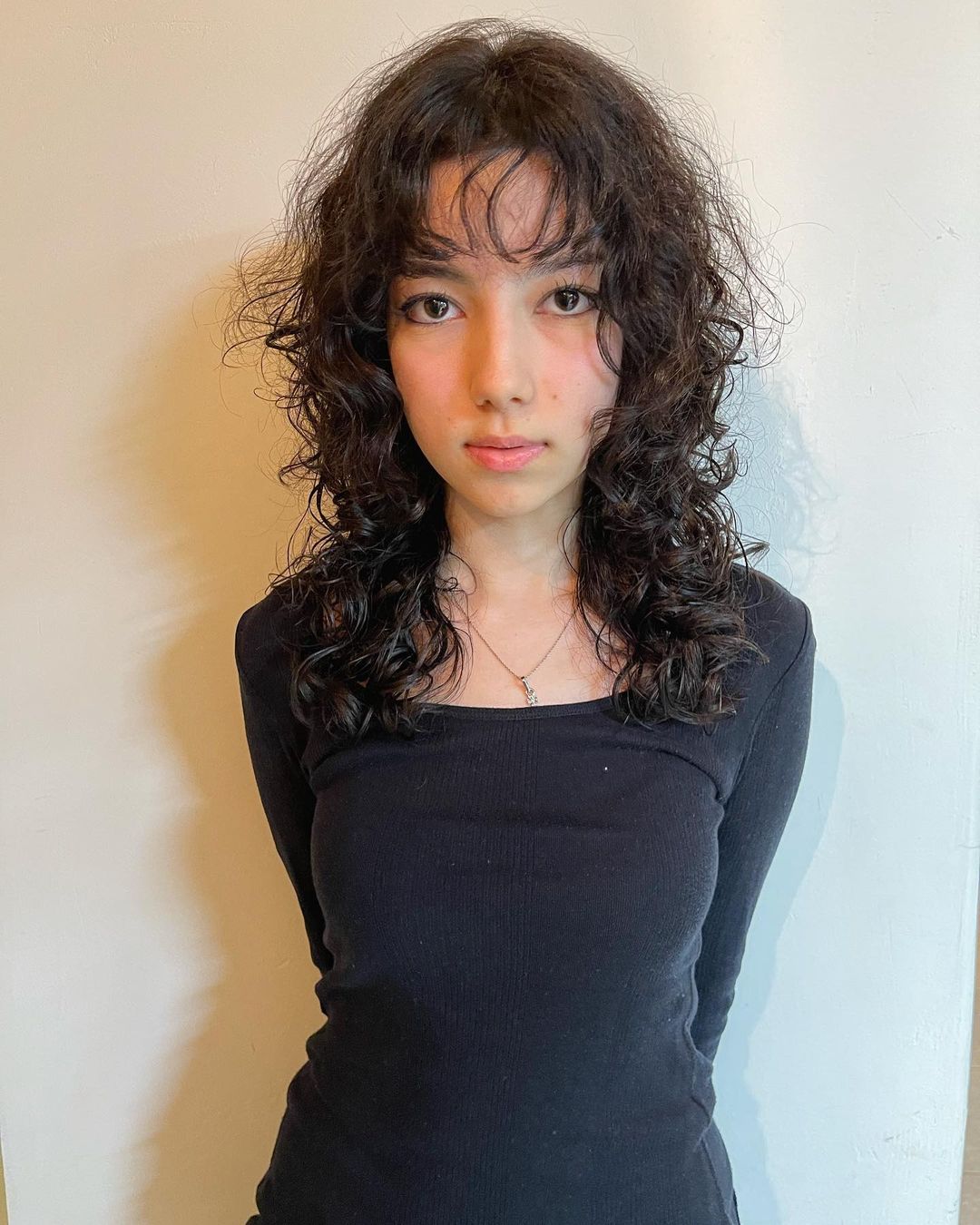 curly wolf cut with bangs
