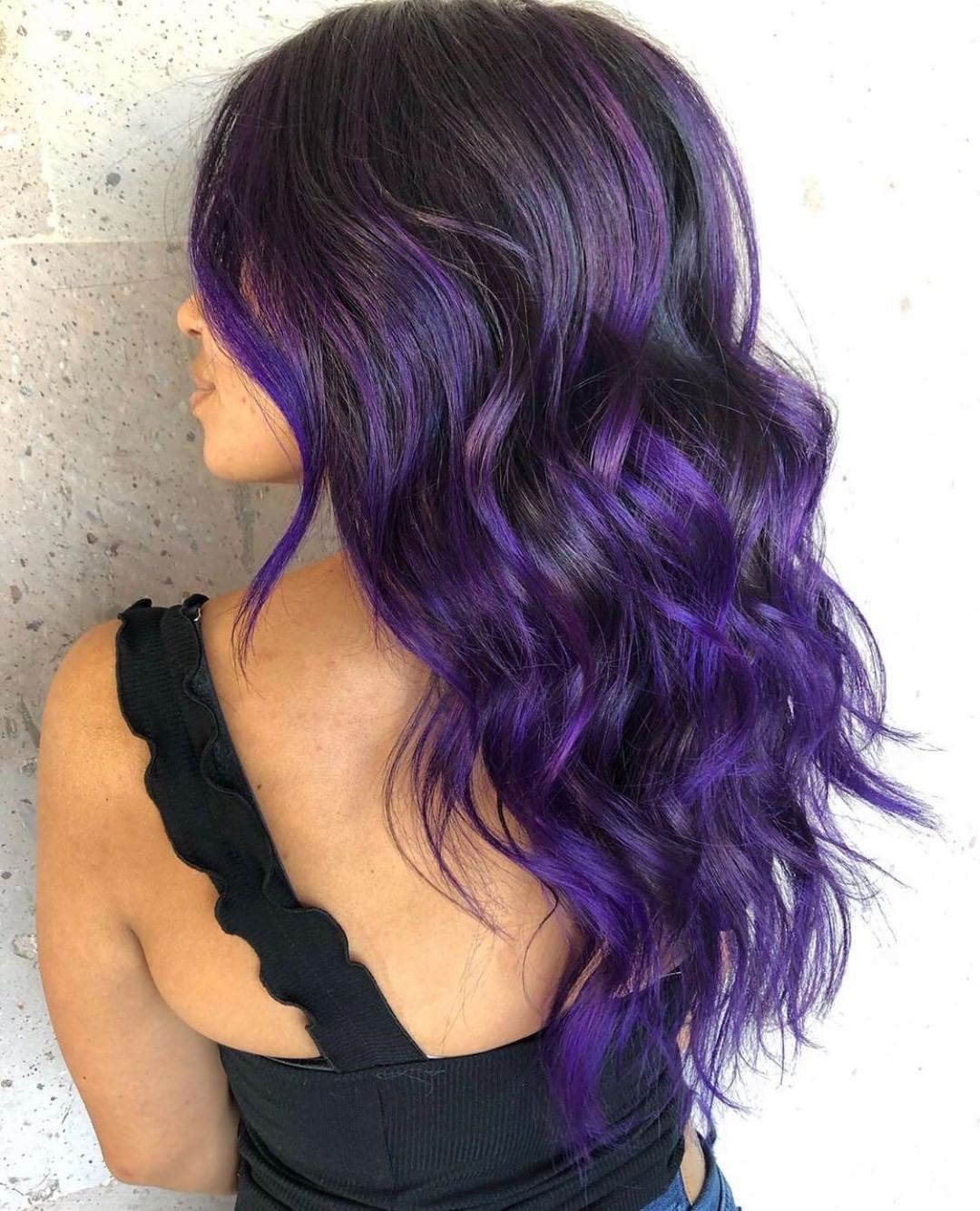 dimensional dark purple hairstyle with face-framing layers