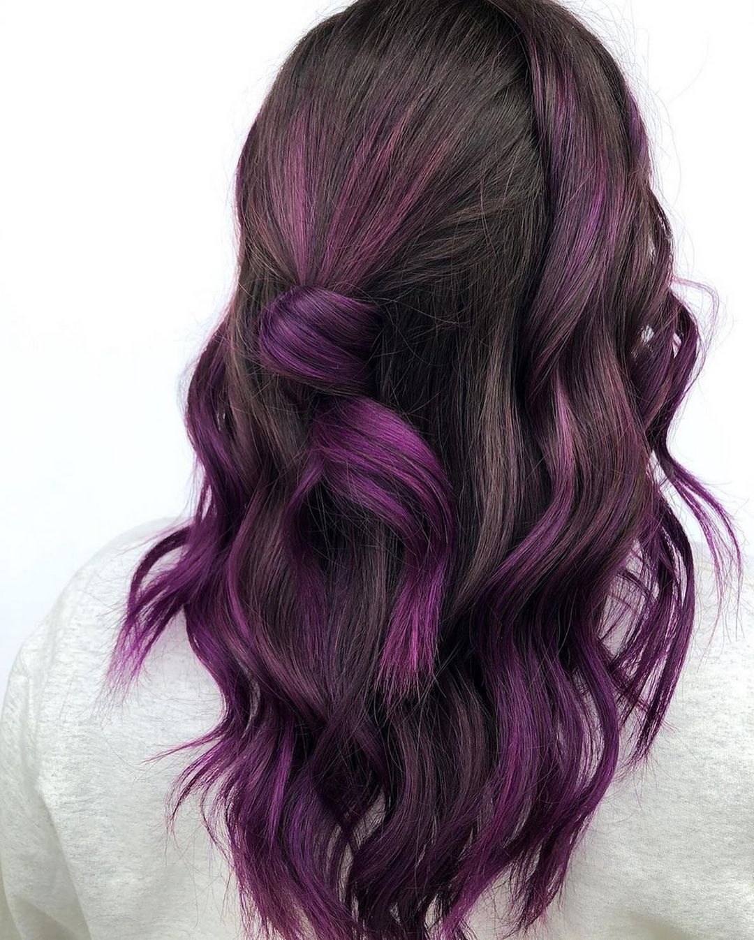 half-up half-down hairstyle with purple highlights