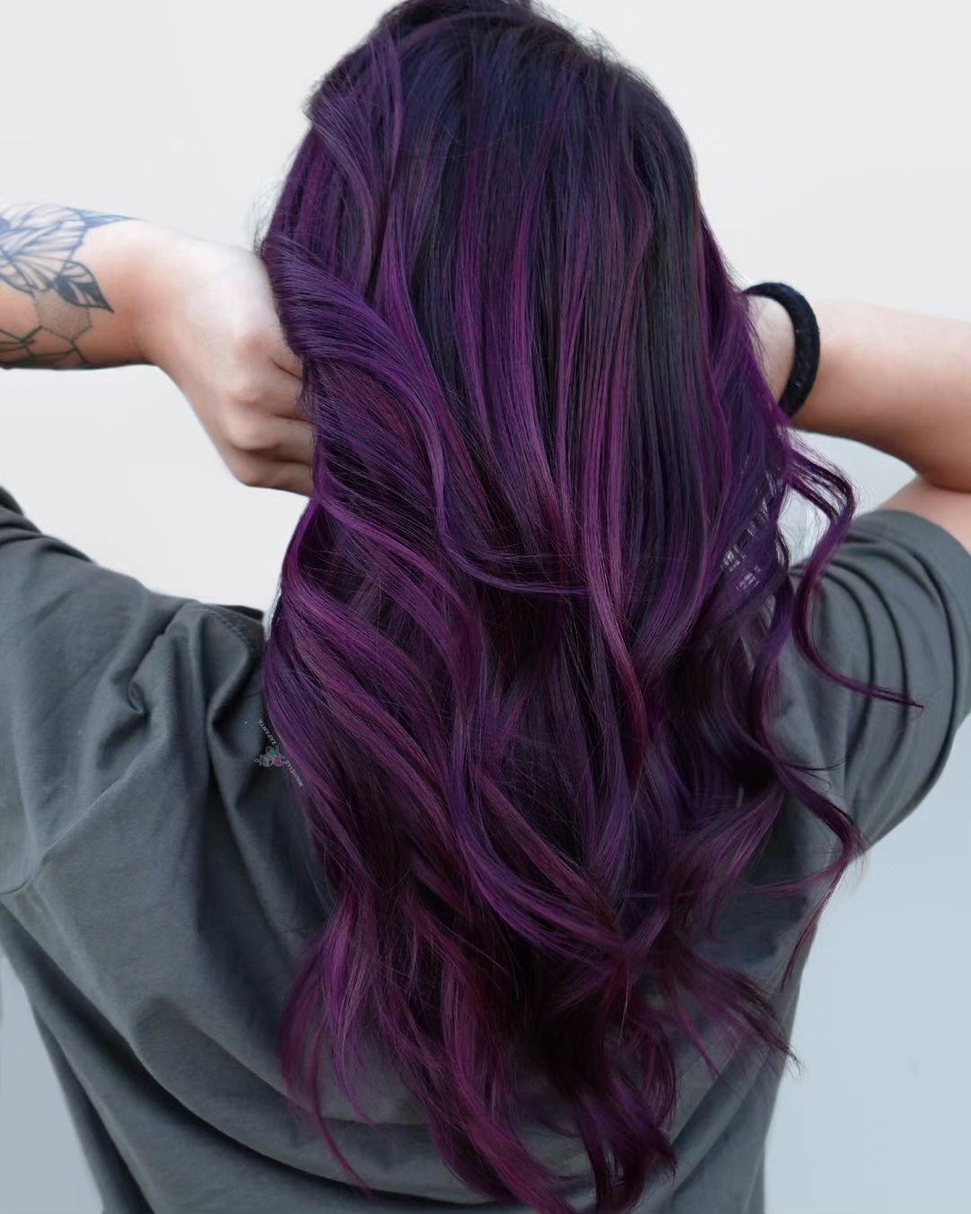 long layered hair with midnight purple highlights