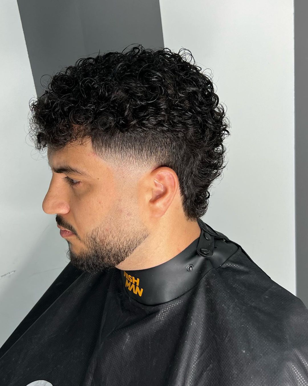 low burst mullet fade for men with curly hair