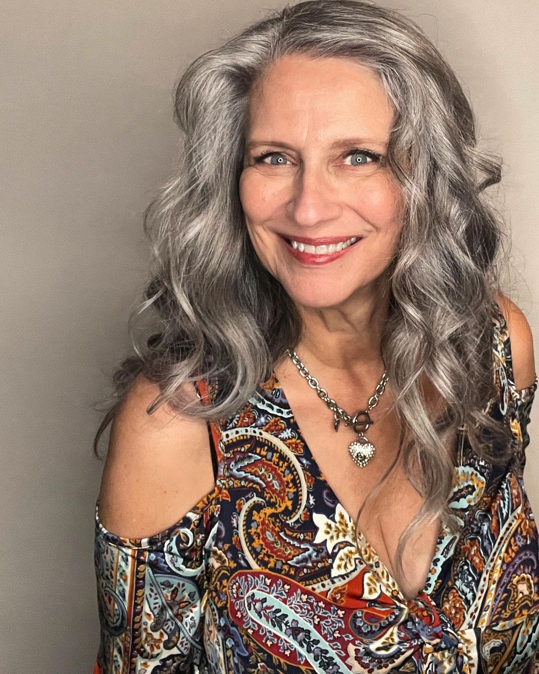 silver curly medium length haircut for women over 50