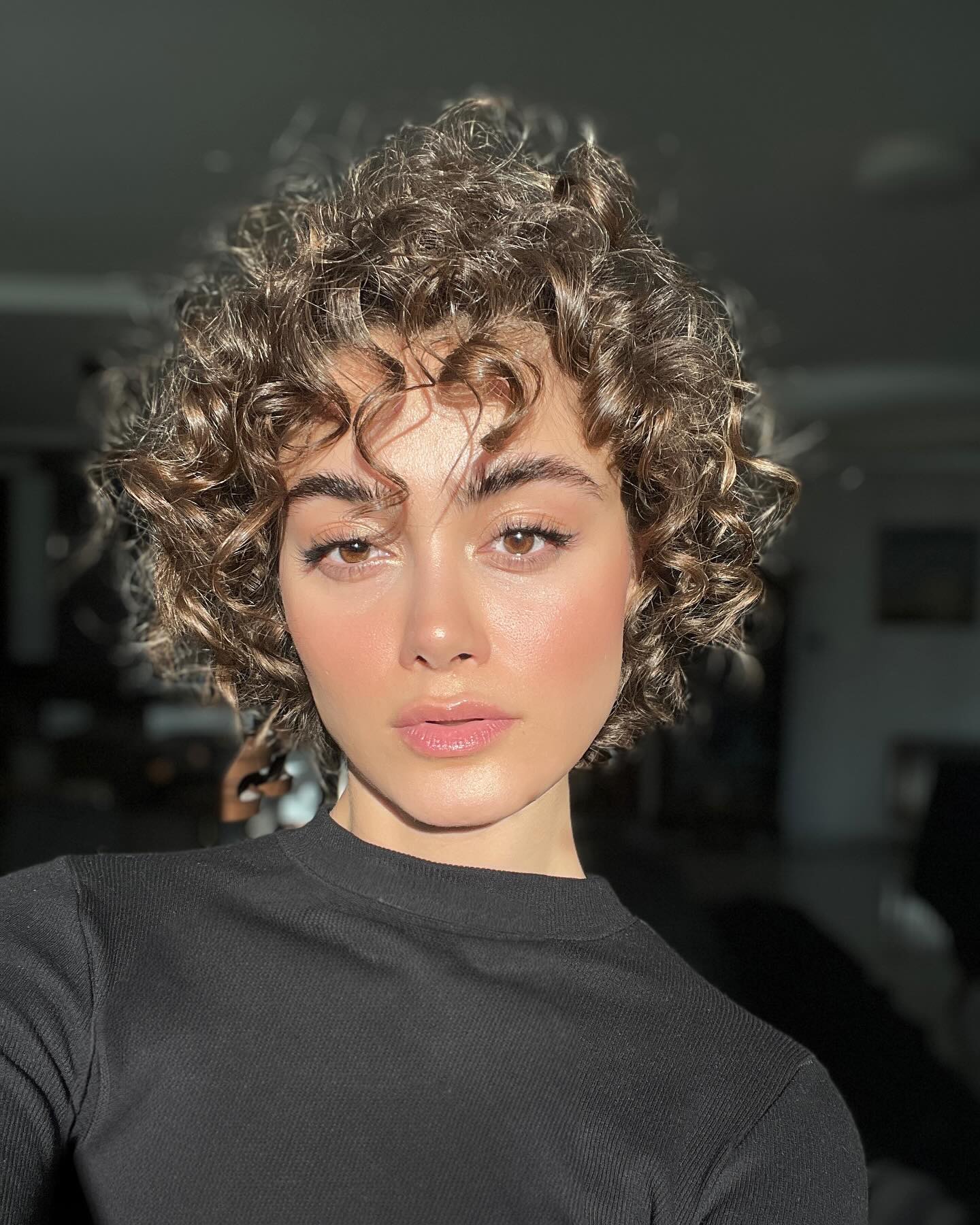 chin-length curls with wispy bangs