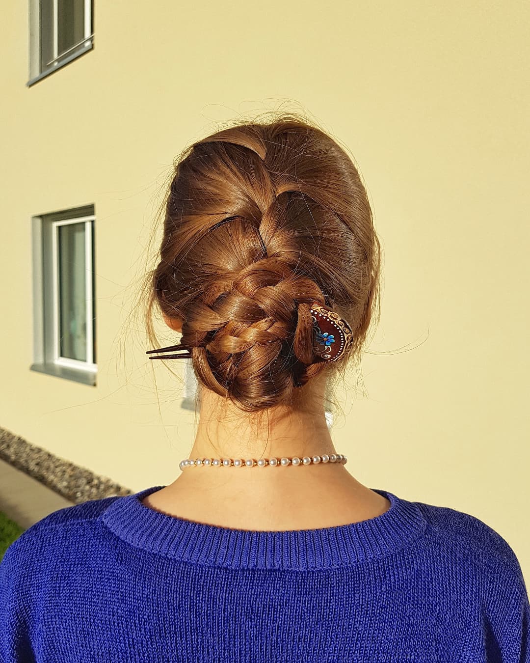 French braided bun with a decorative hair pin