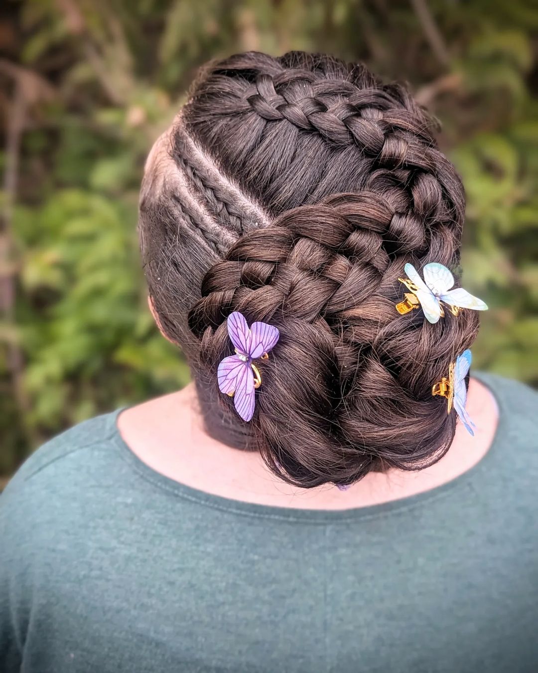 braided bun updo with butterfly clips