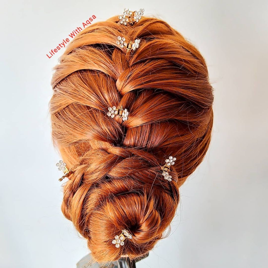 copper braided bun with decorative hair pins