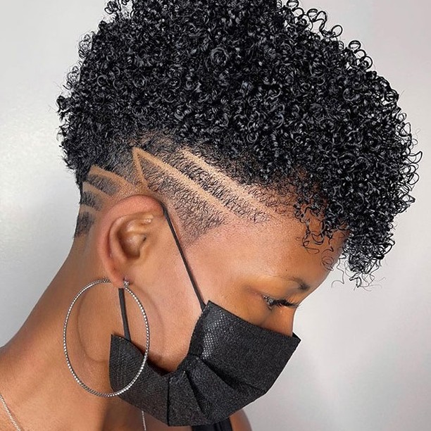 short curly hairstyle with shaved sides lines hair design
