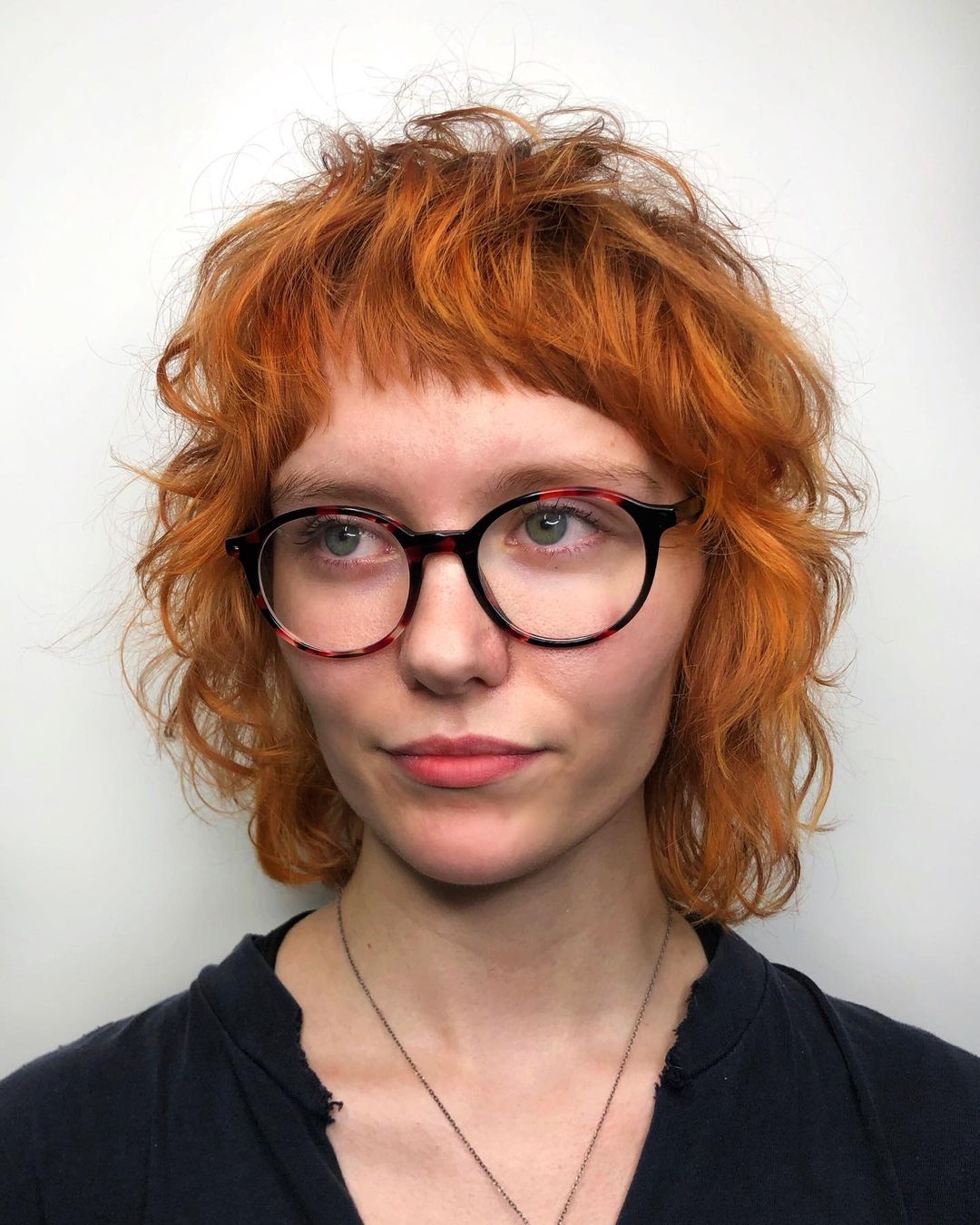 short shag with bangs on wavy copper hair