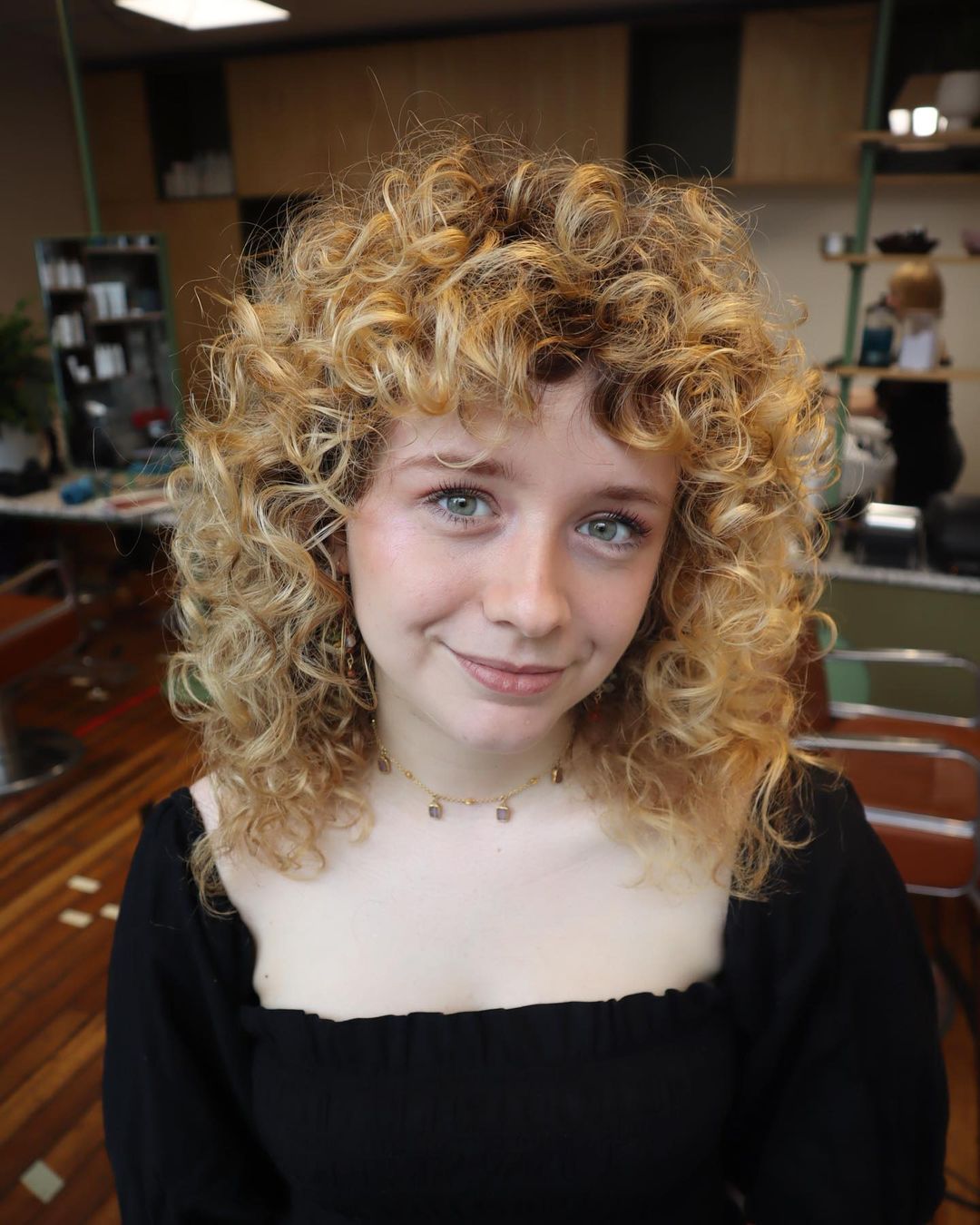 wolf cut on curly blonde hair