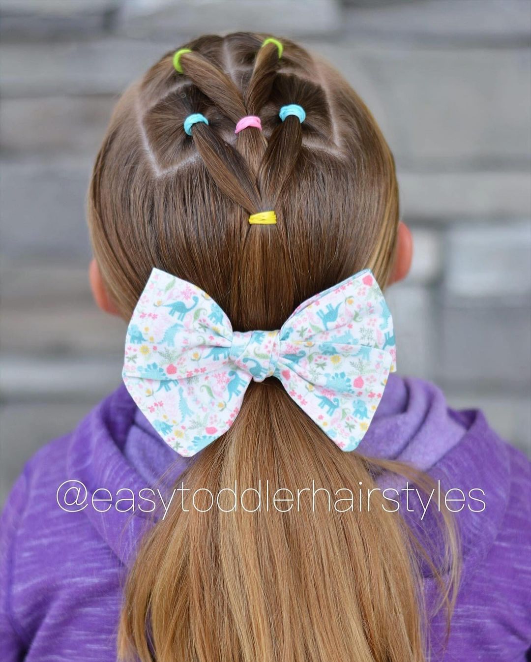 bubble braids into a low ponytail with a bow