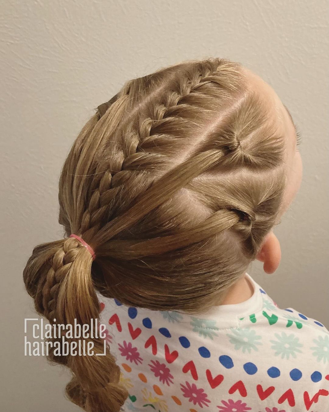 french braid with flips and a bubble ponytail