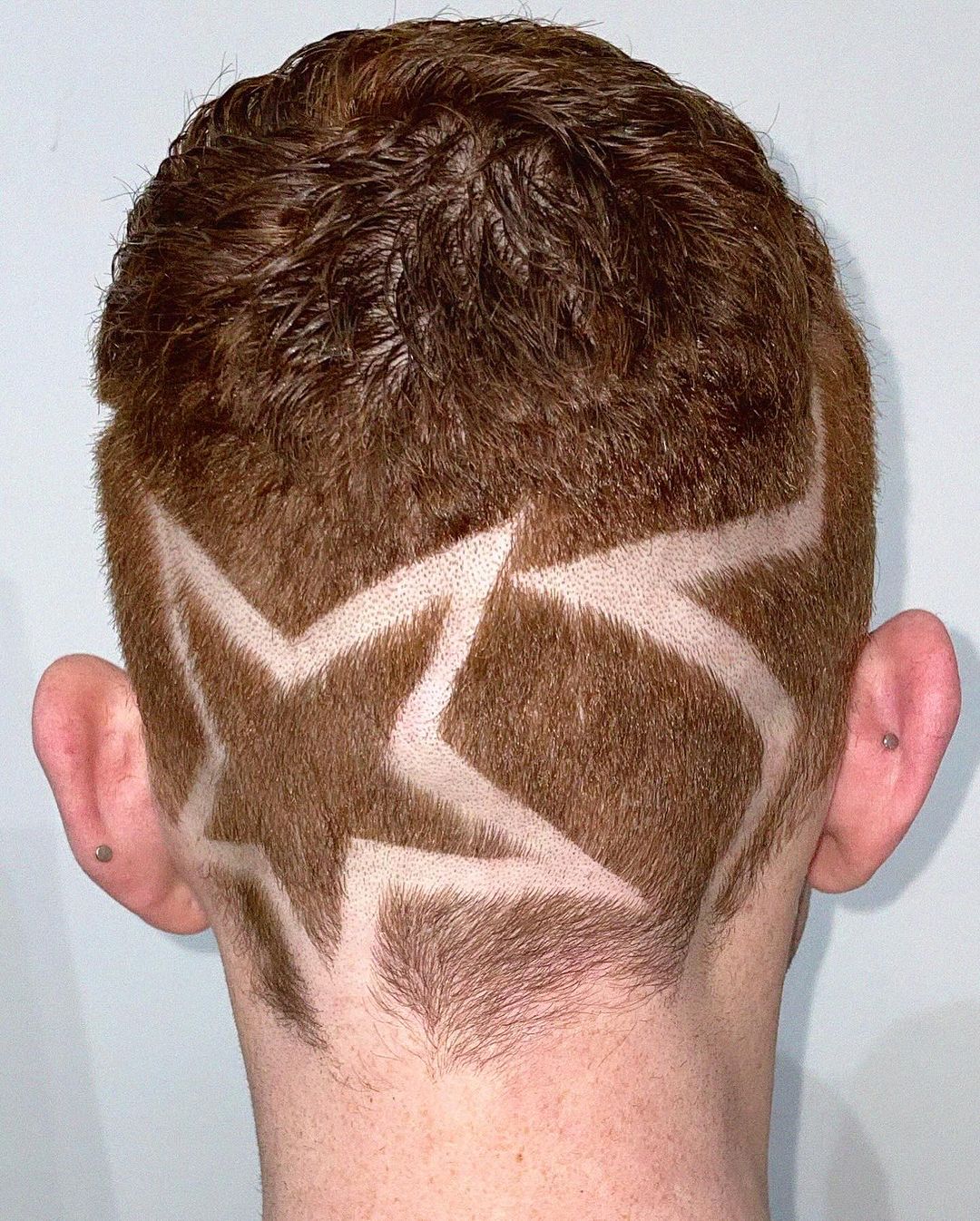 high taper fade with shaved stars design