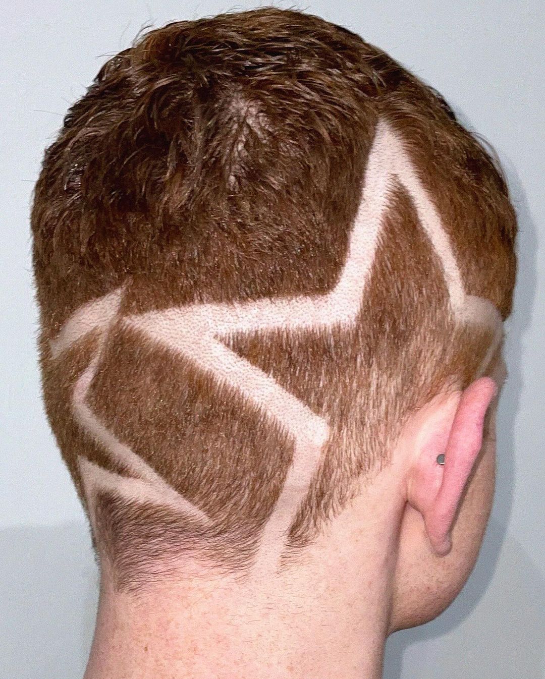 high taper fade with shaved stars design