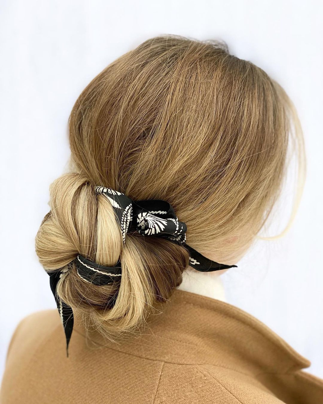low messy bun with a scarf
