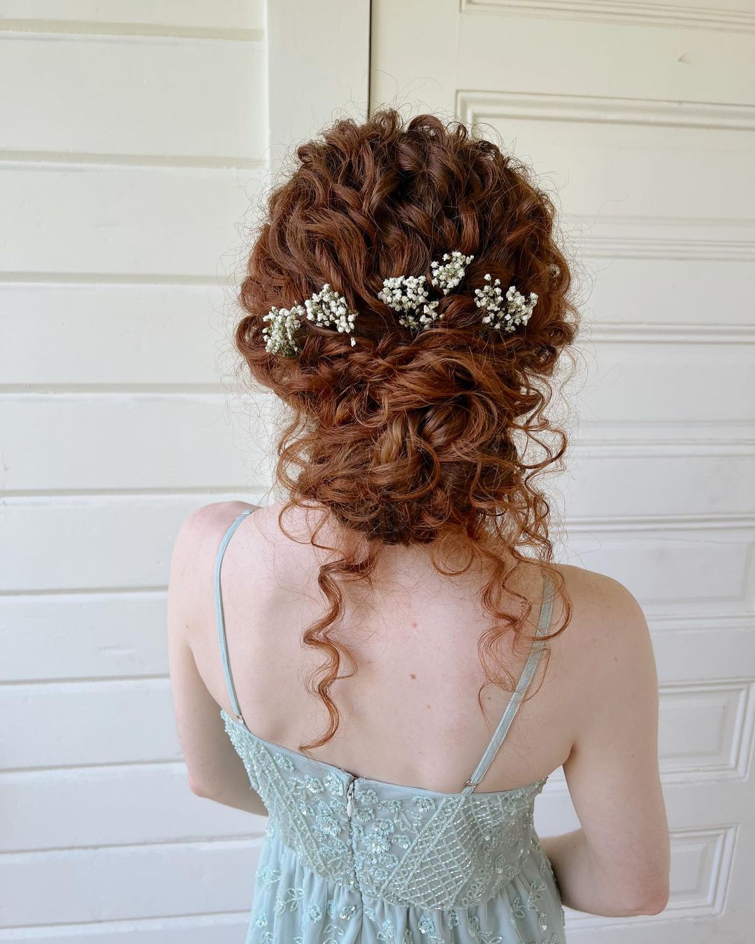 messy curly bun with flowers