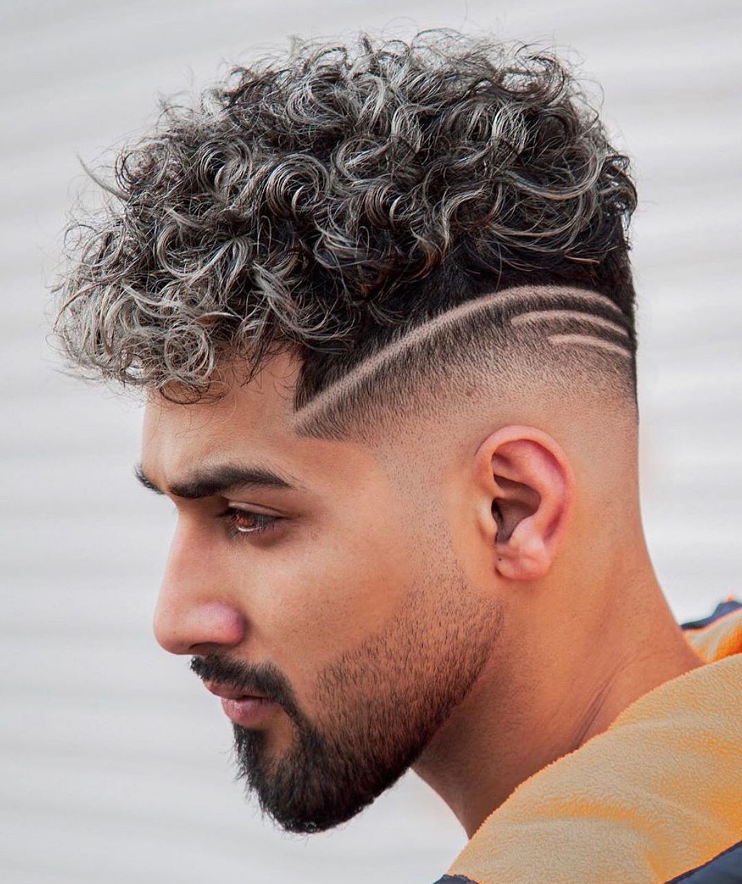 mid fade with curly hair on top