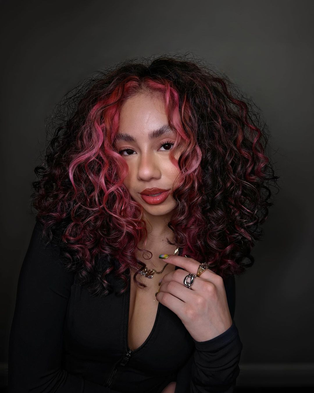 pastel pink money piece on brown curly hair