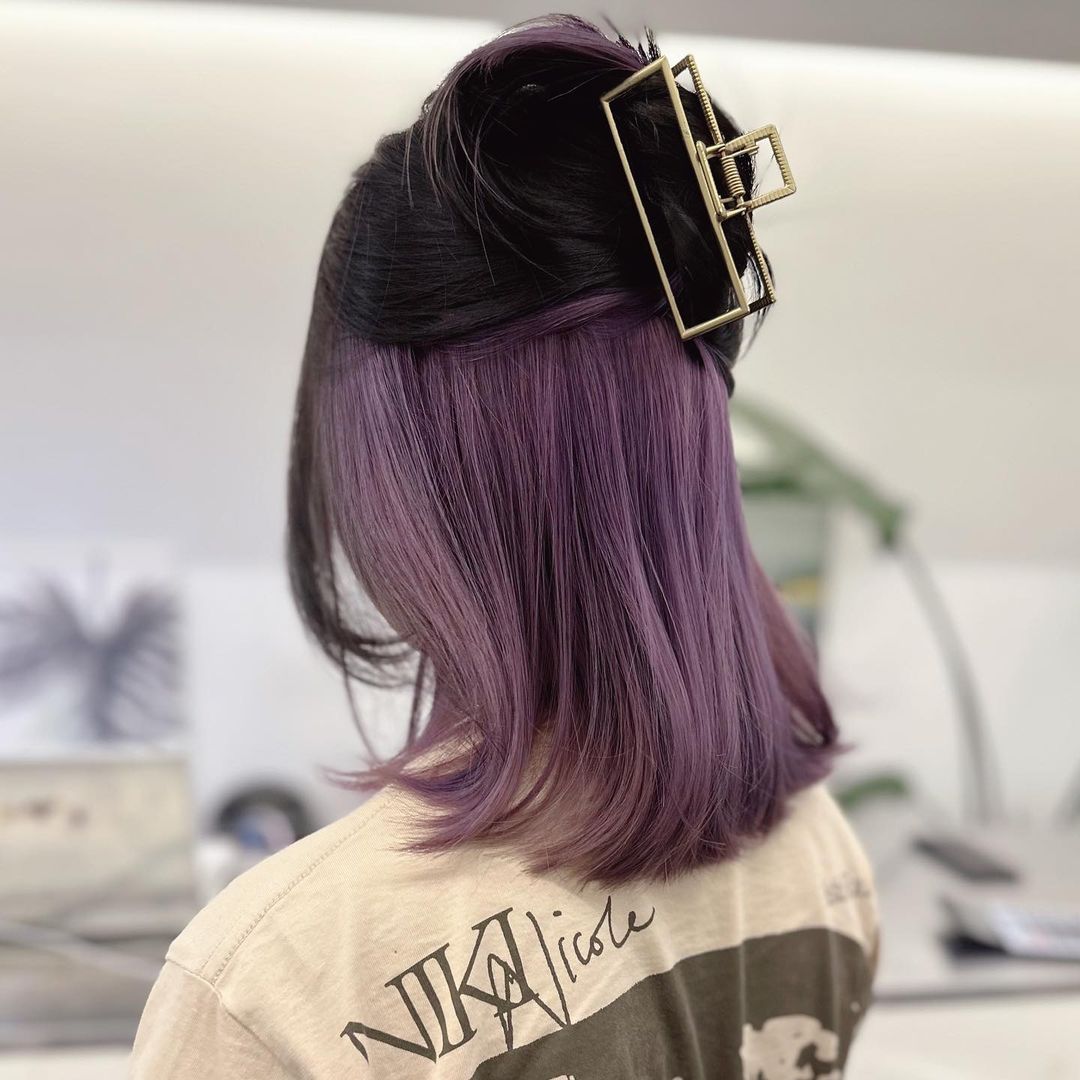 pastel purple peekaboo highlights on brown hair