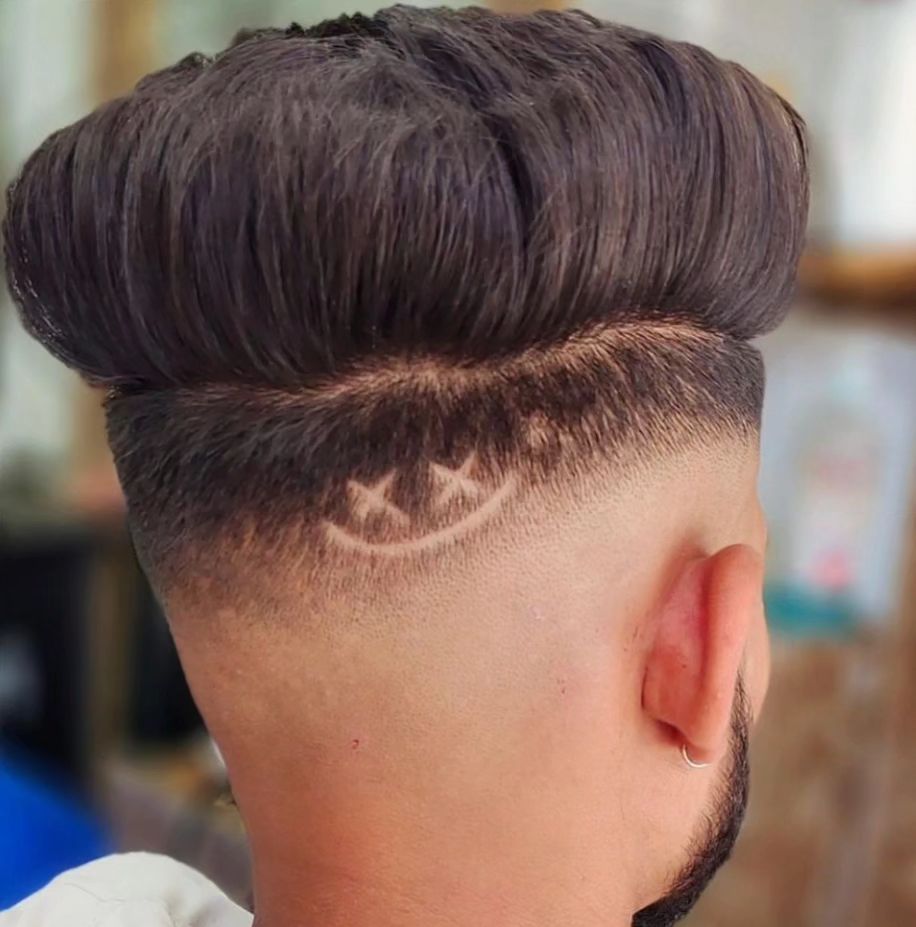 pompadour taper fade with a smiley design