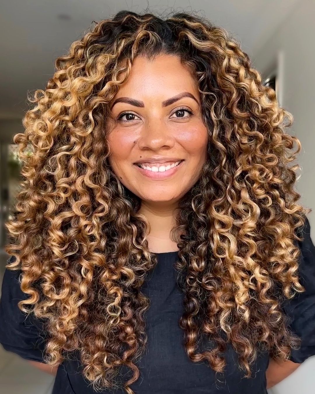 sunkissed golden beige curly balayage