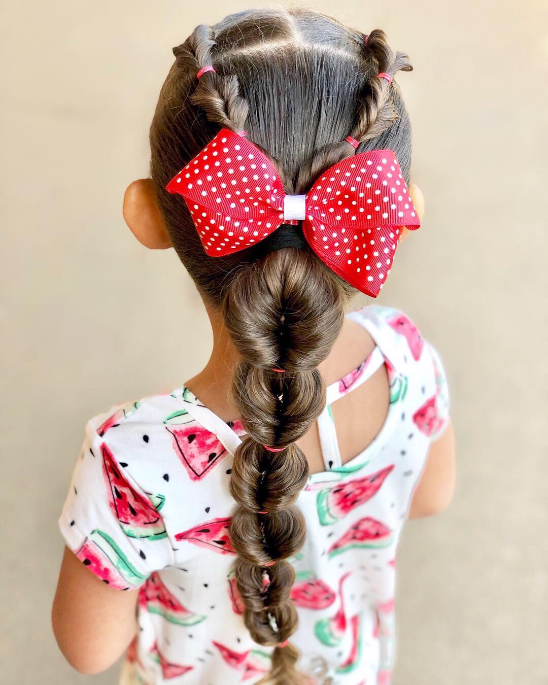 topsy tail braids with a bow