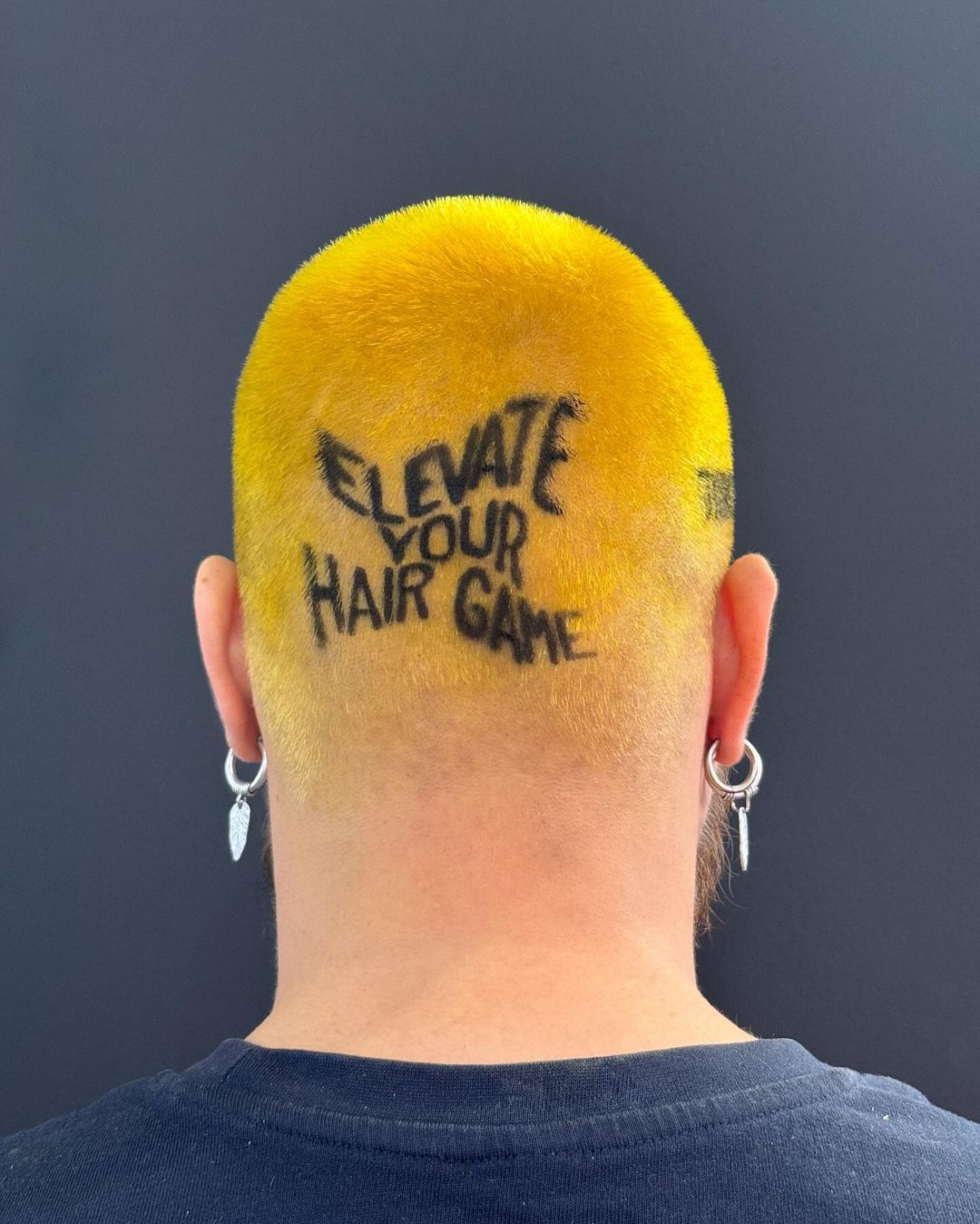 yellow buzz cut with hair tattoo
