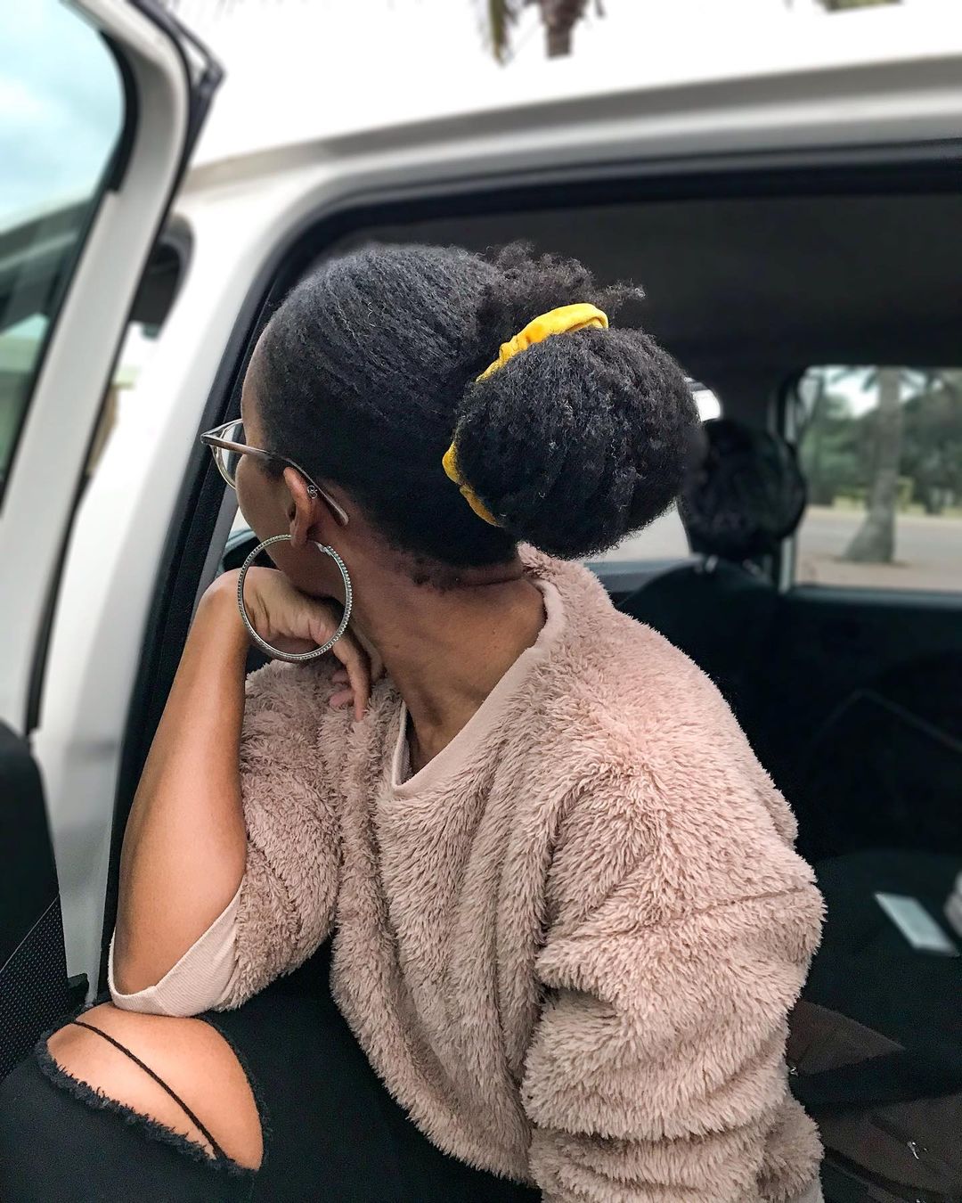 low bun with a colorful scrunchie