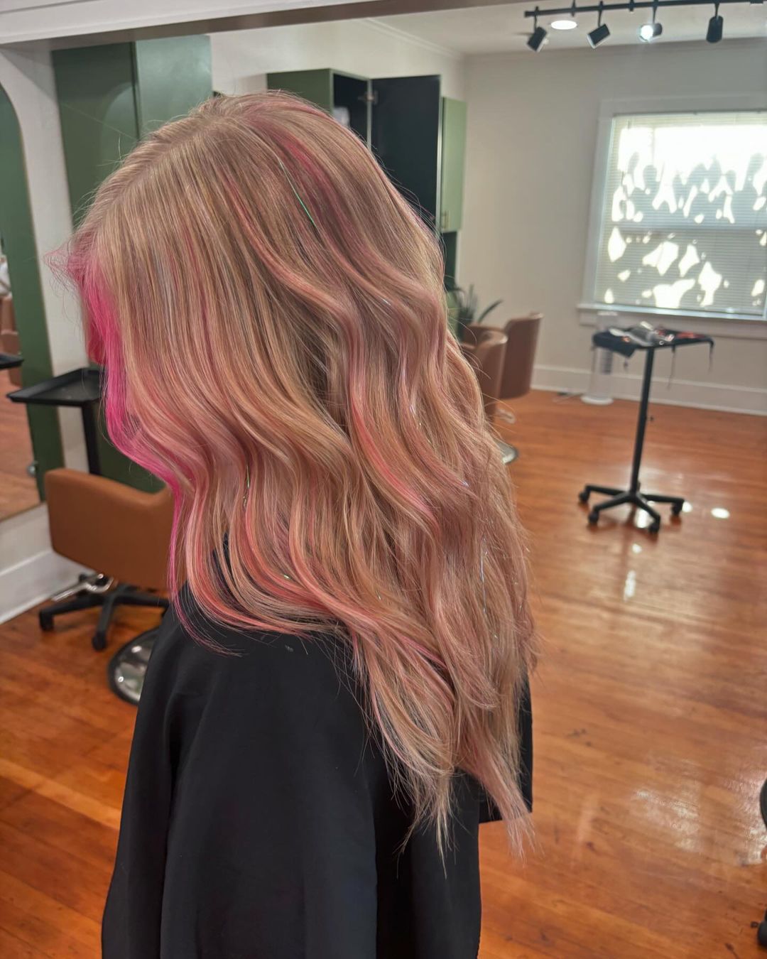 subtle pink highlights on blonde hair