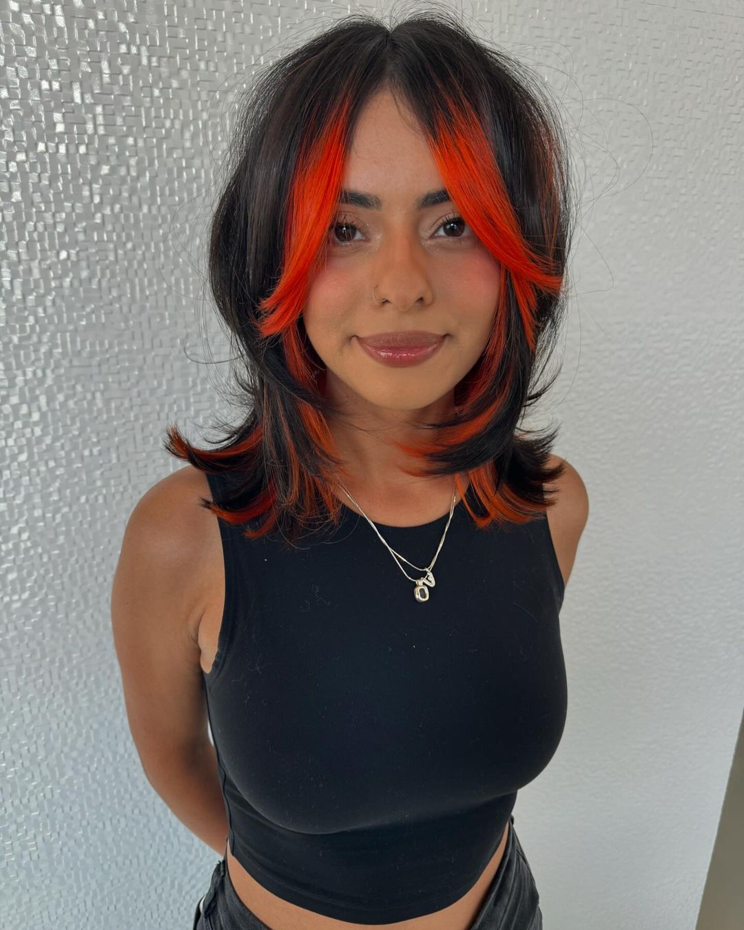 cabelo preto com madeixas cor de laranja a emoldurar o rosto