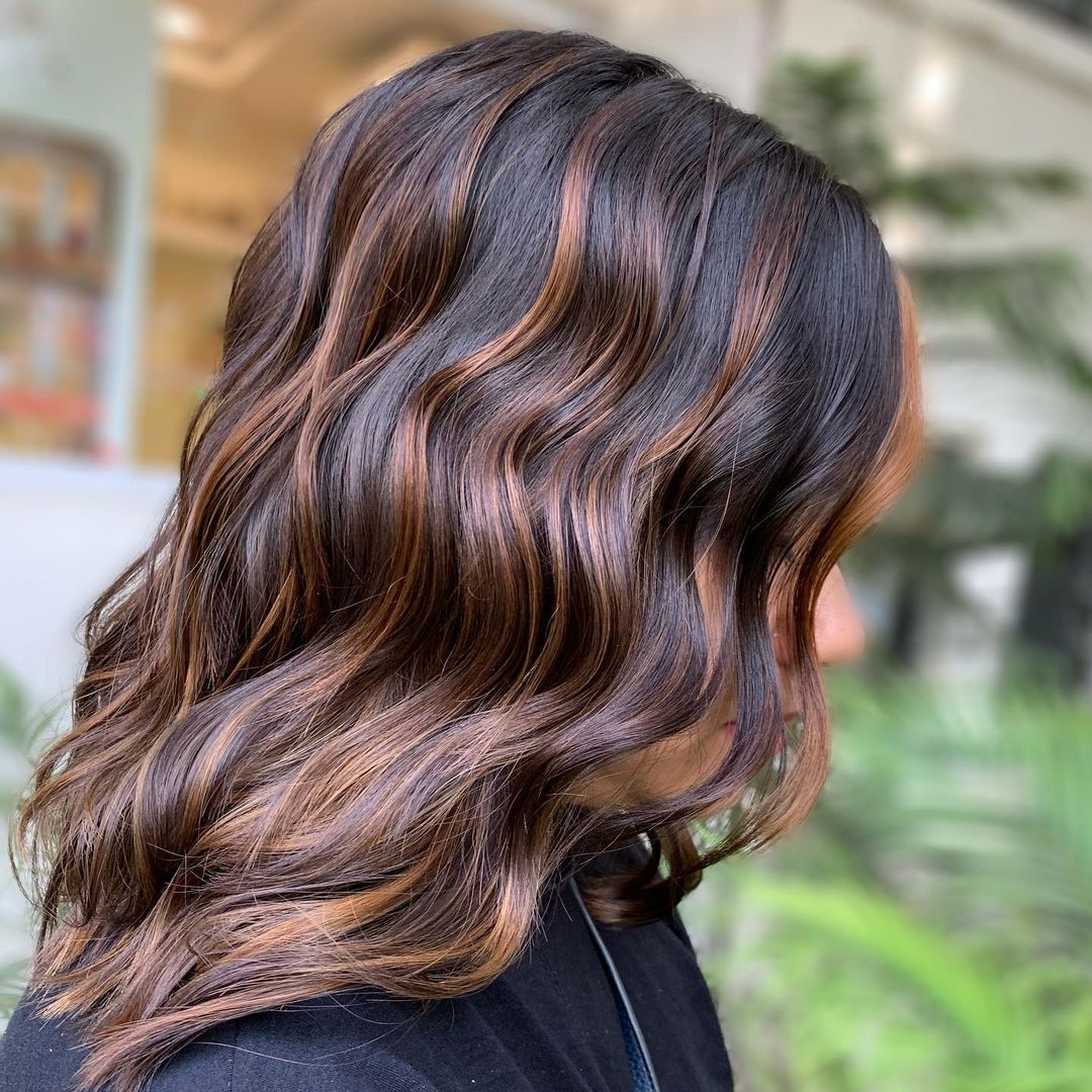 brown wavy hair with cinnamon streaks