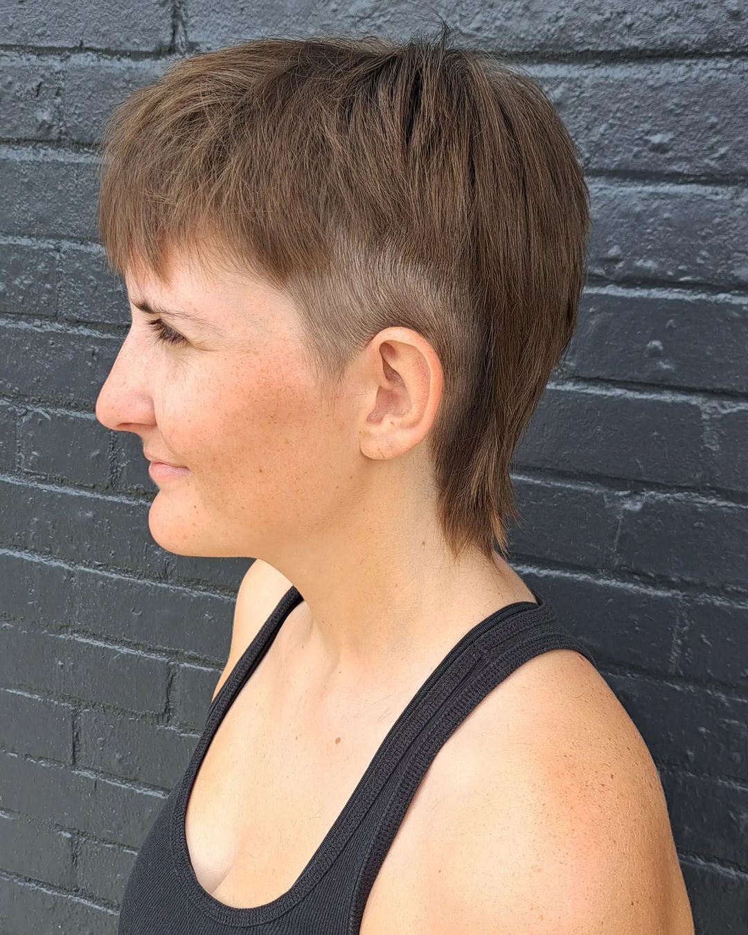 light brown pixie mullet with shaved sides