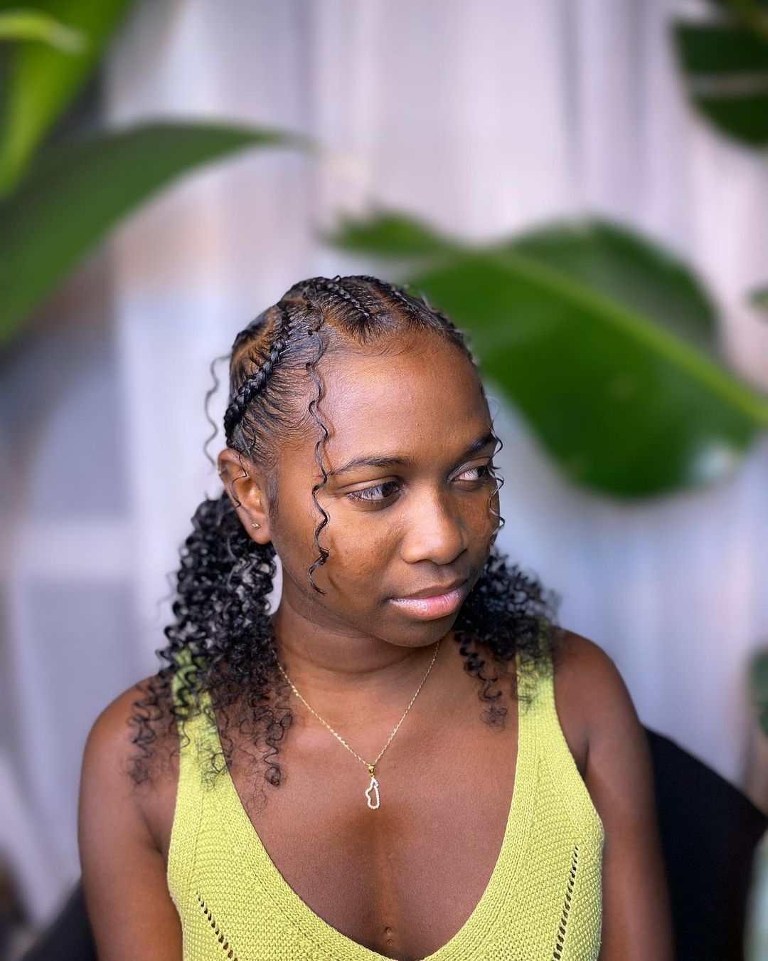 C-shaped cornrow braids into curly pigtails