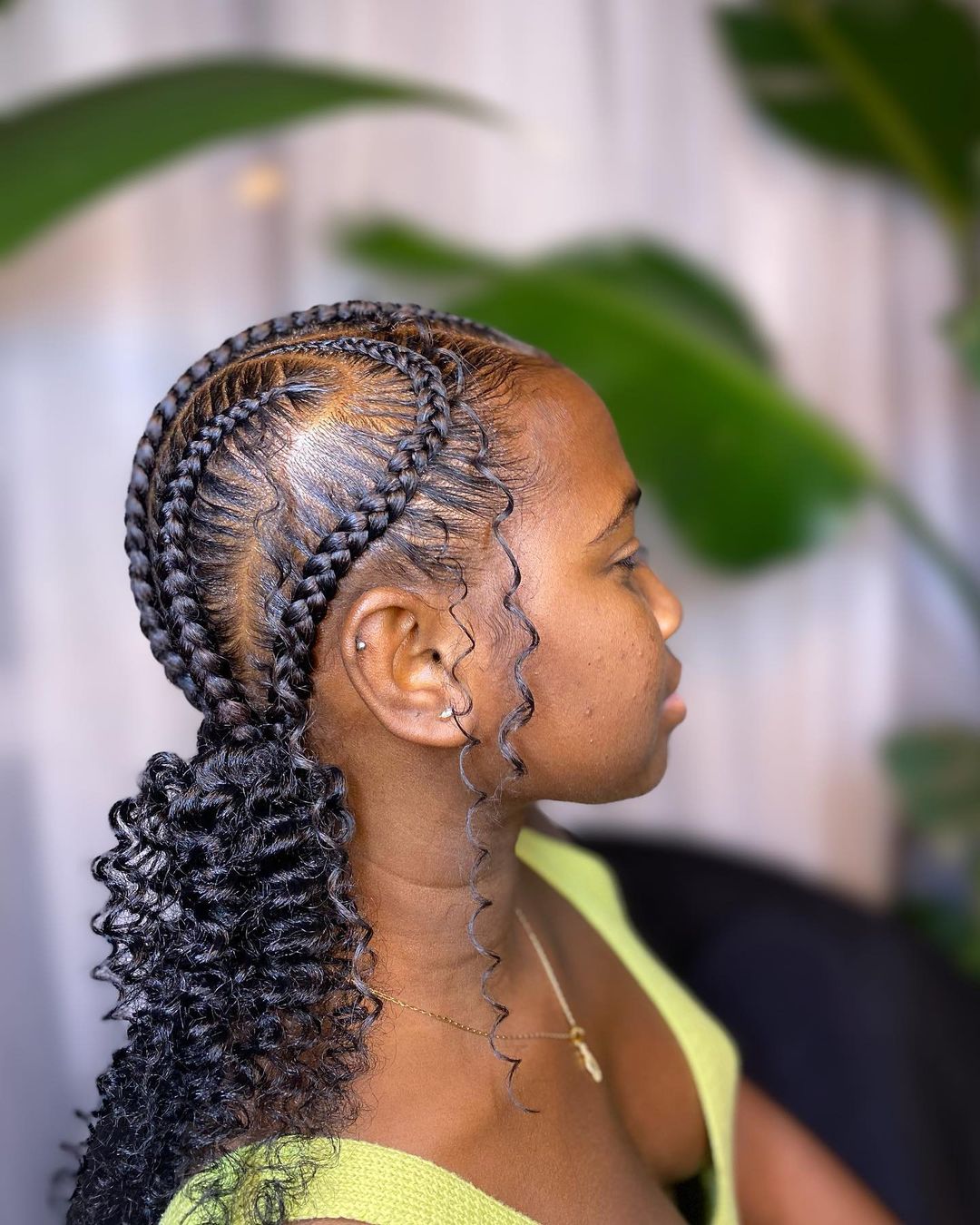 C-shaped cornrow braids into curly pigtails