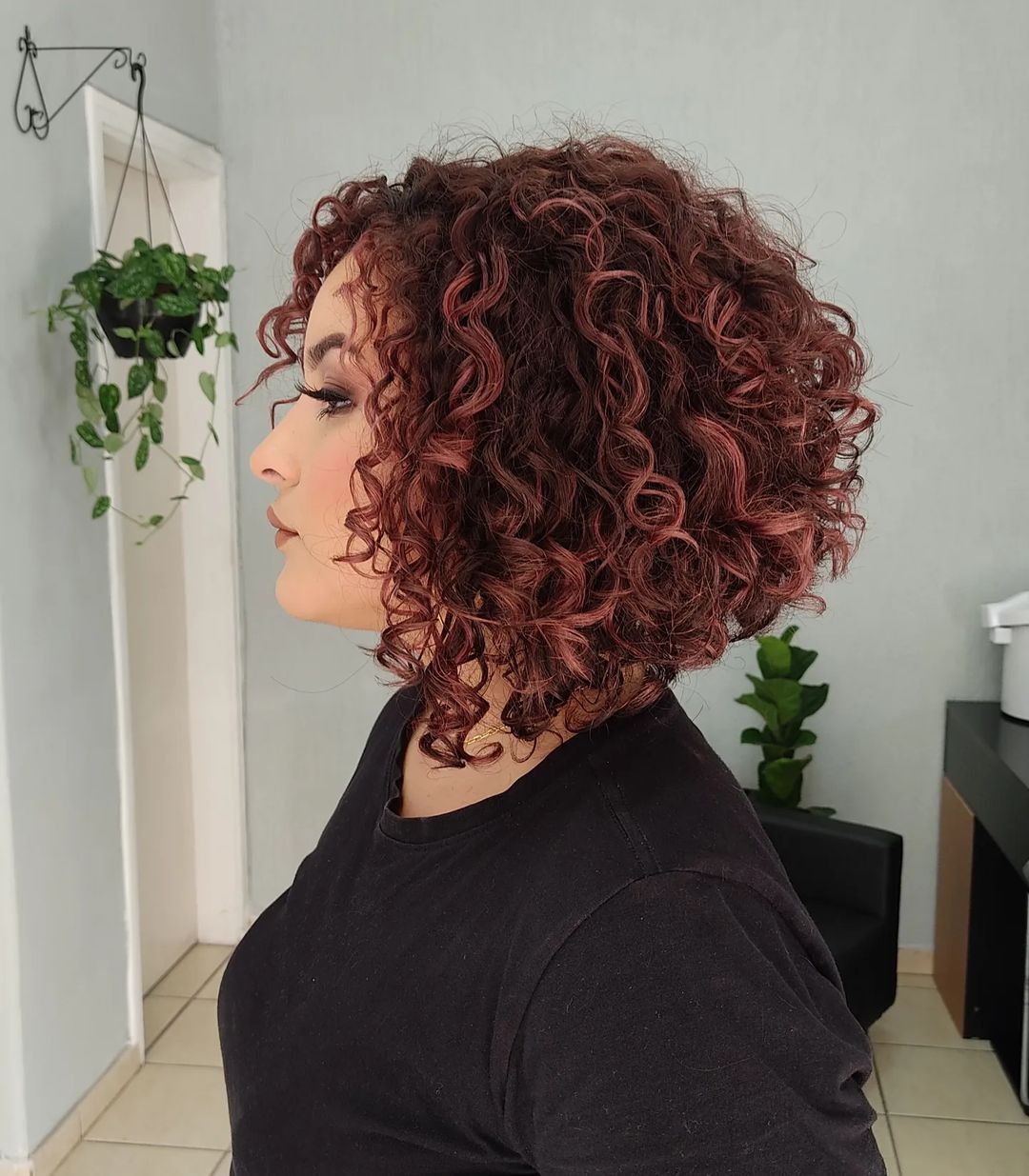 angled curly bob with highlights