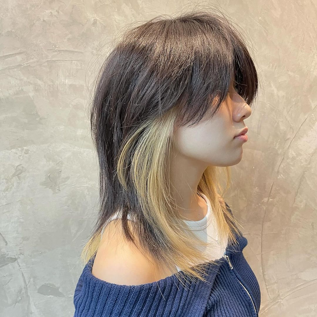 kitty cut with blonde peekaboo highlights